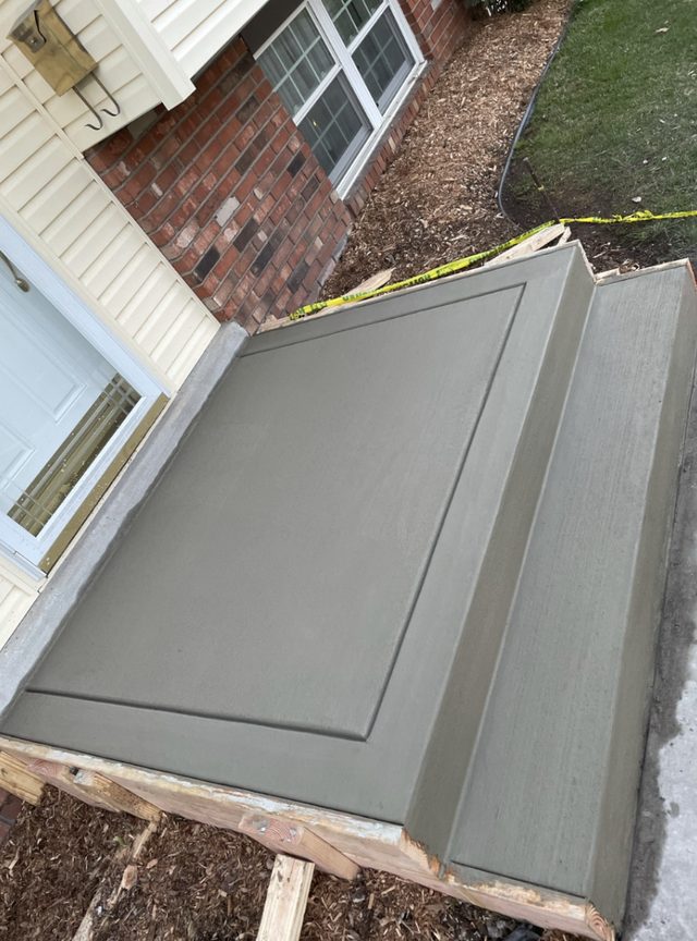 Concrete front steps and landing at a residential entry