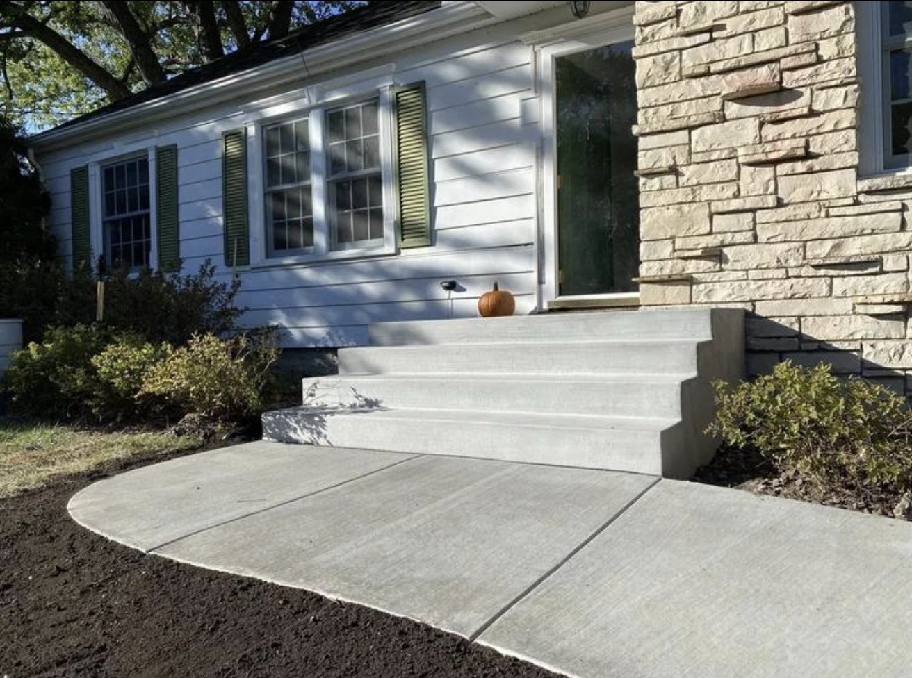 New concrete front steps and landing with a curved walkway in South Jersey