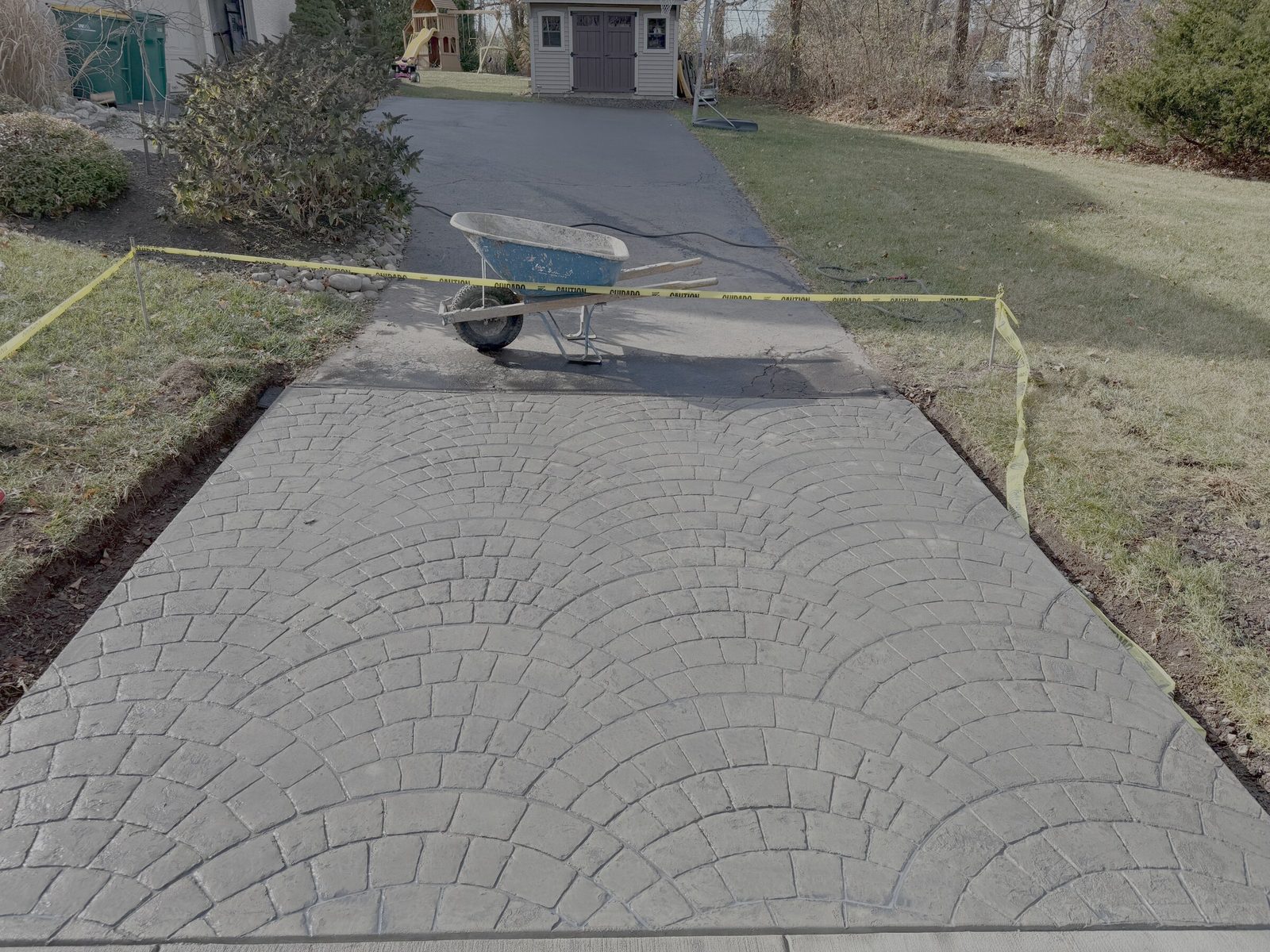 Stamped concrete residential driveway with circular pattern