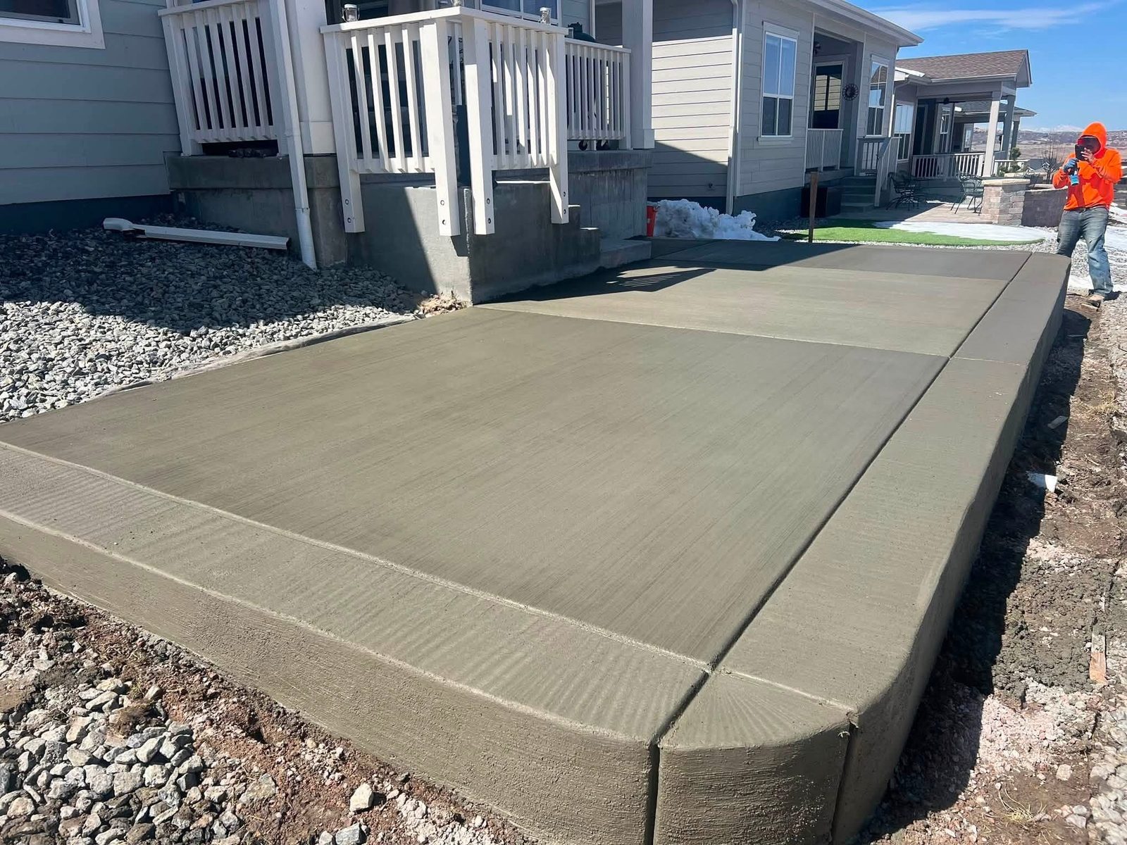 Freshly finished brushed concrete patio with rounded corner