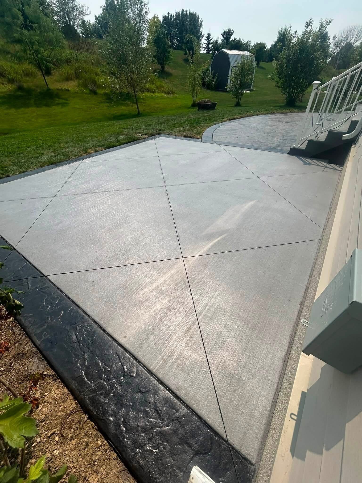 Overhead view of a two-tone concrete backyard patio