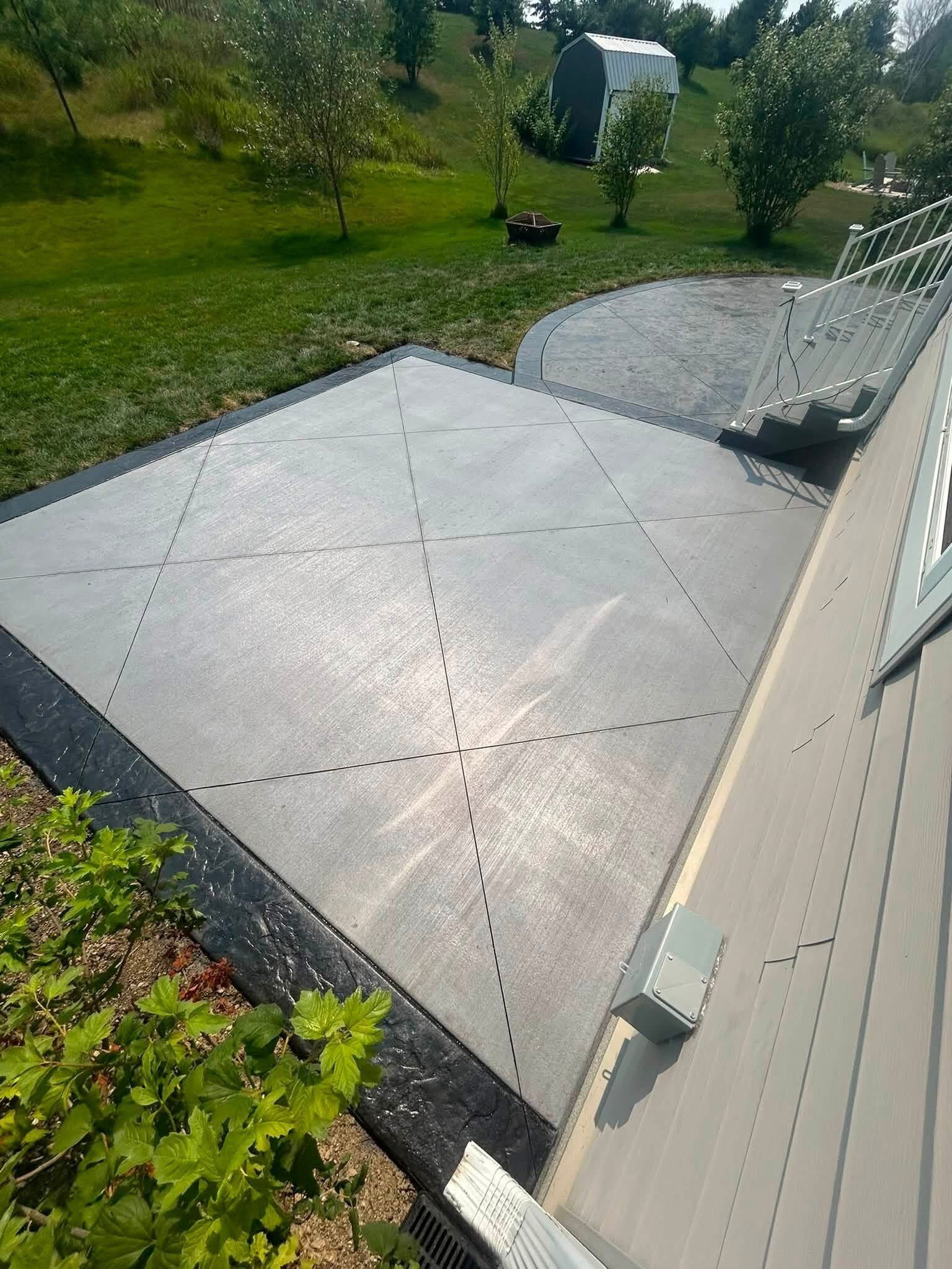 Overhead view of a finished concrete patio and curved border