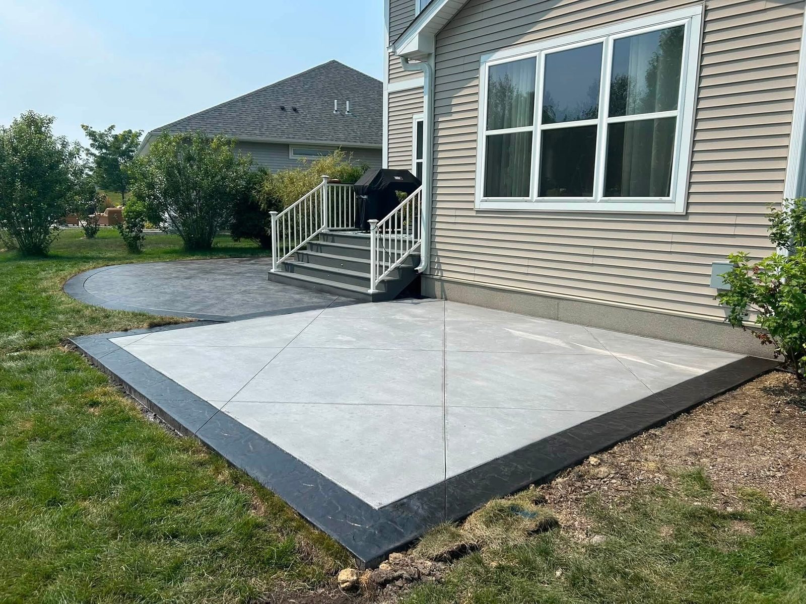 Finished concrete patio slab with a dark border
