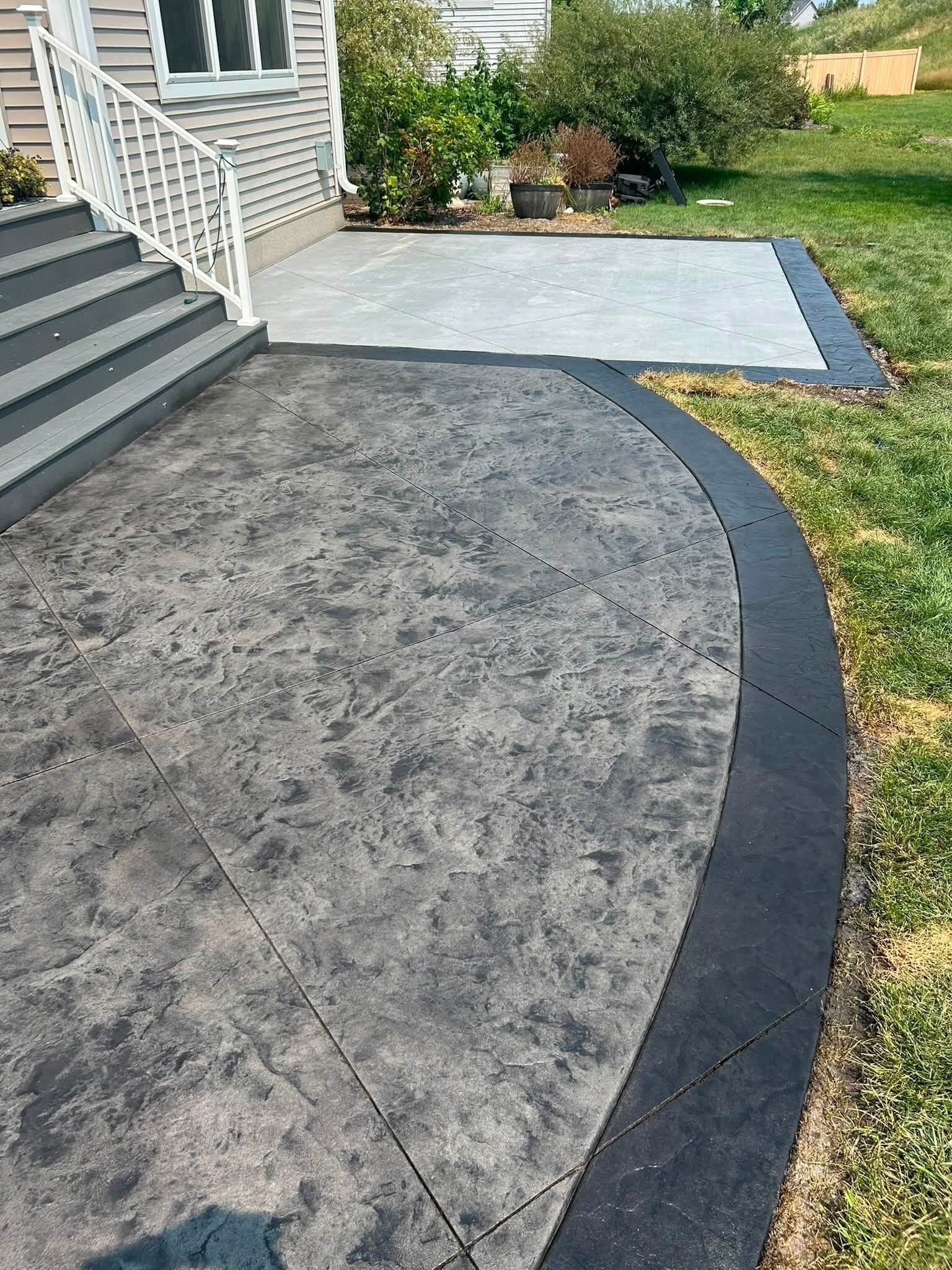 Close view of a stamped concrete patio with dark border