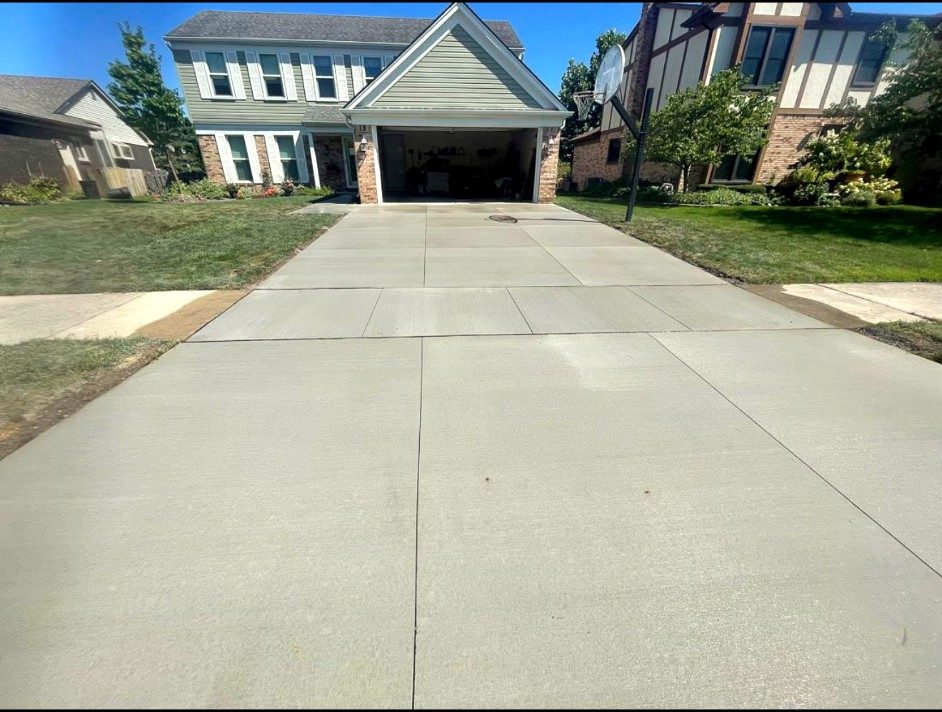 Finished concrete driveway running the length of a South Jersey home