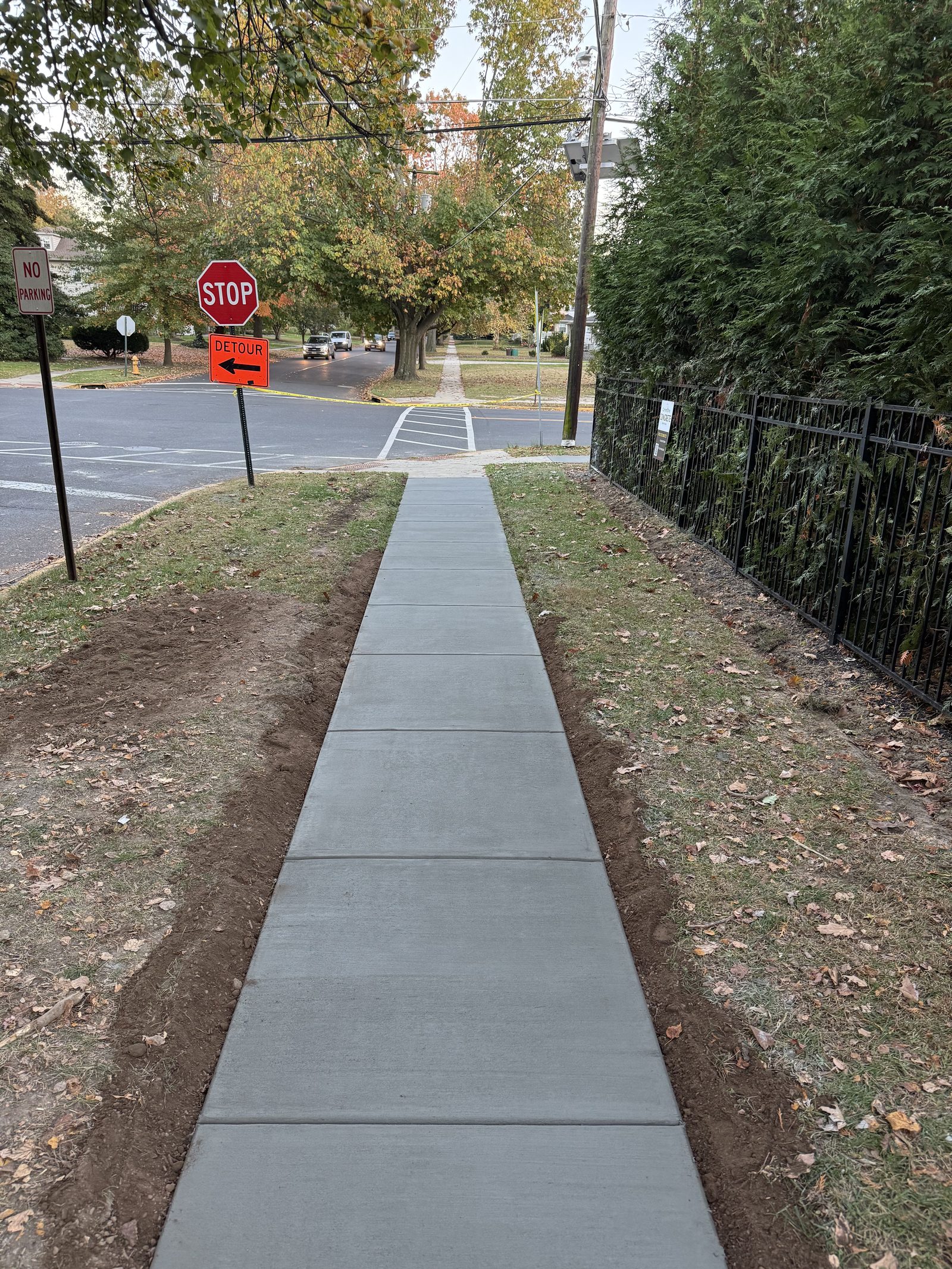 Curved concrete driveway with a paver border leading to a garage