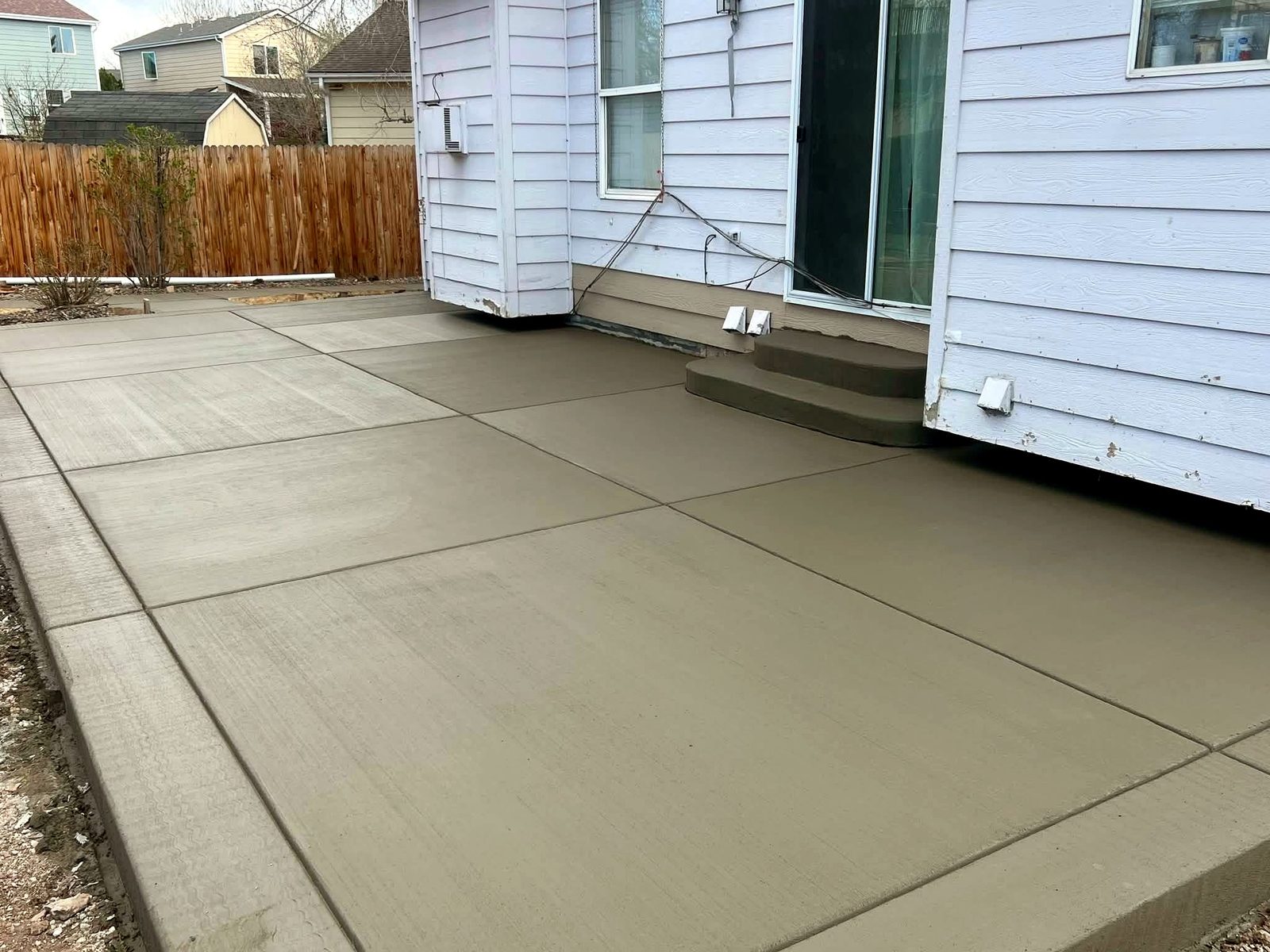 Brushed concrete patio in an open backyard with clean edges