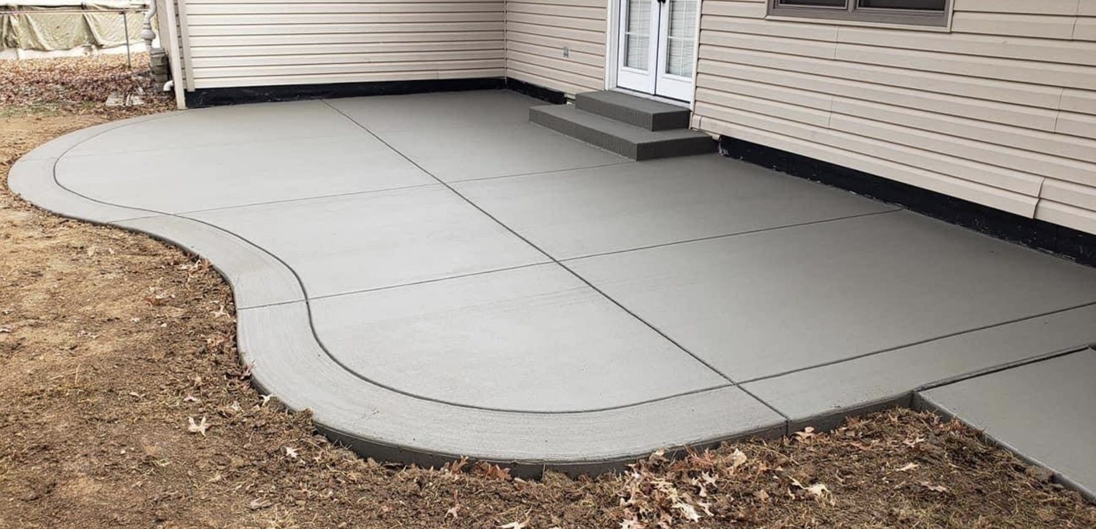 Concrete patio joined to a poured step landing