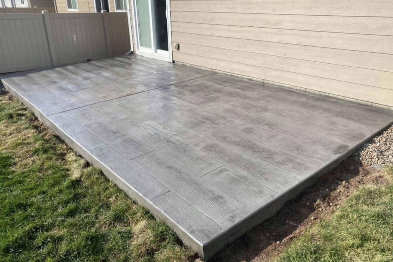 Gray stamped concrete patio with an ashlar stone pattern