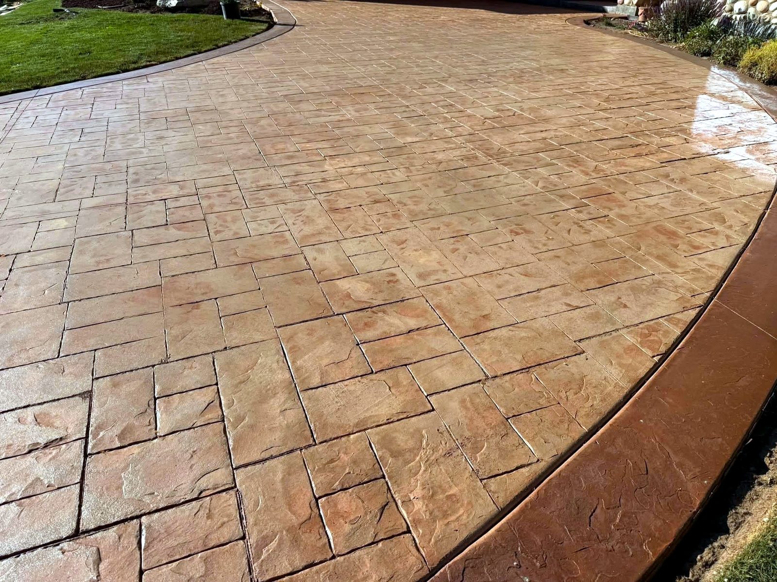 Tan stamped concrete patio with an ashlar stone pattern