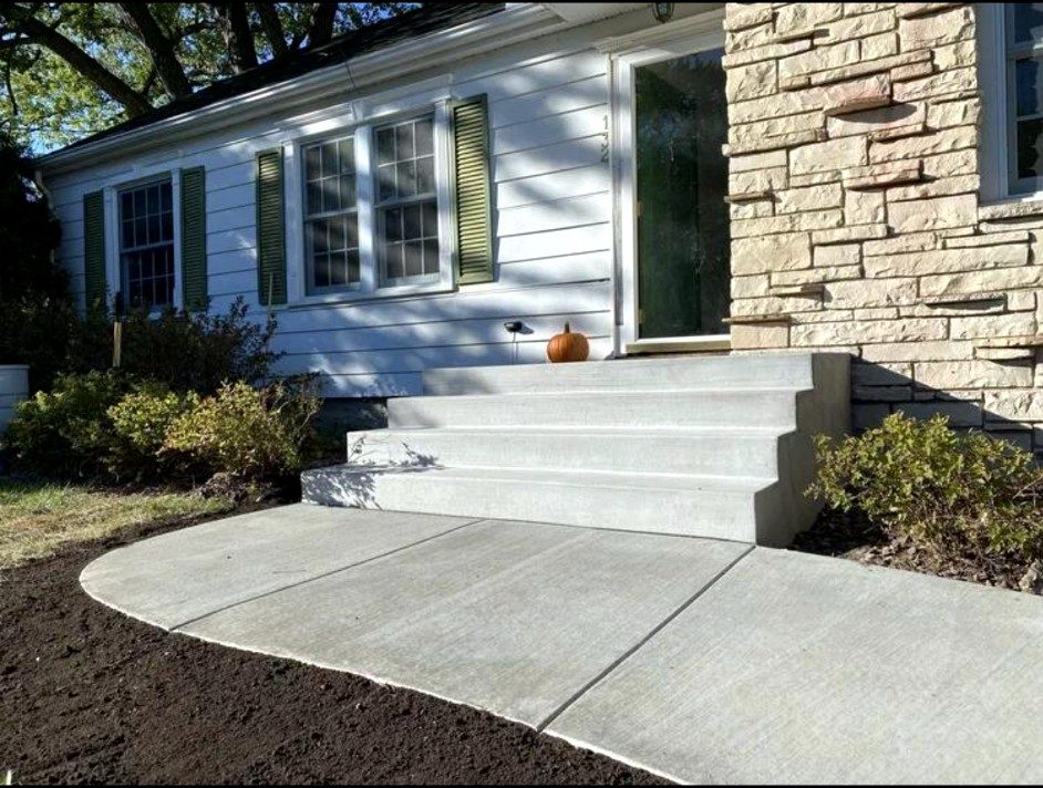 New concrete front steps with a curved entry walkway