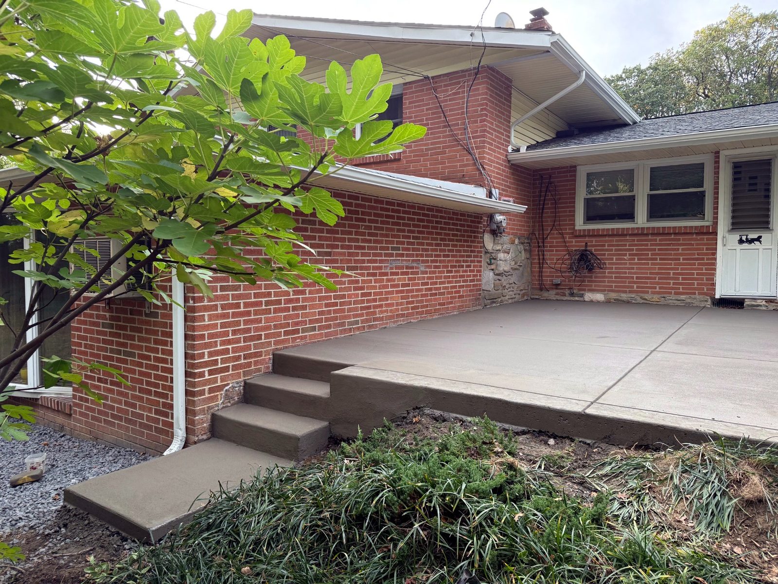 Concrete porch steps and landing at a brick South Jersey home