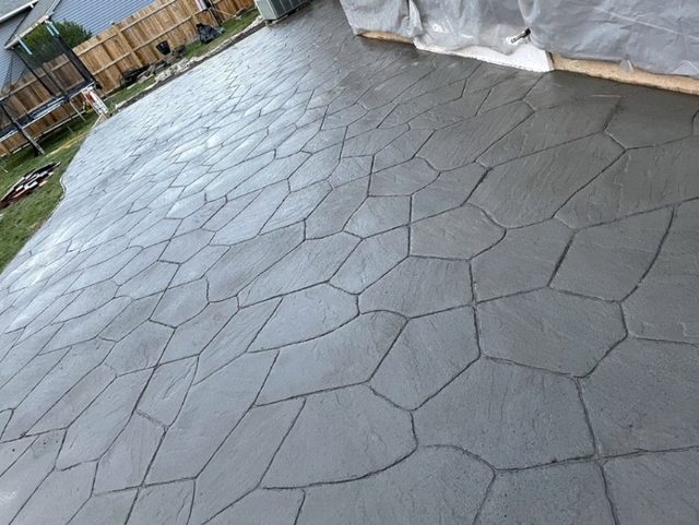 Stamped concrete surface with a textured stone pattern